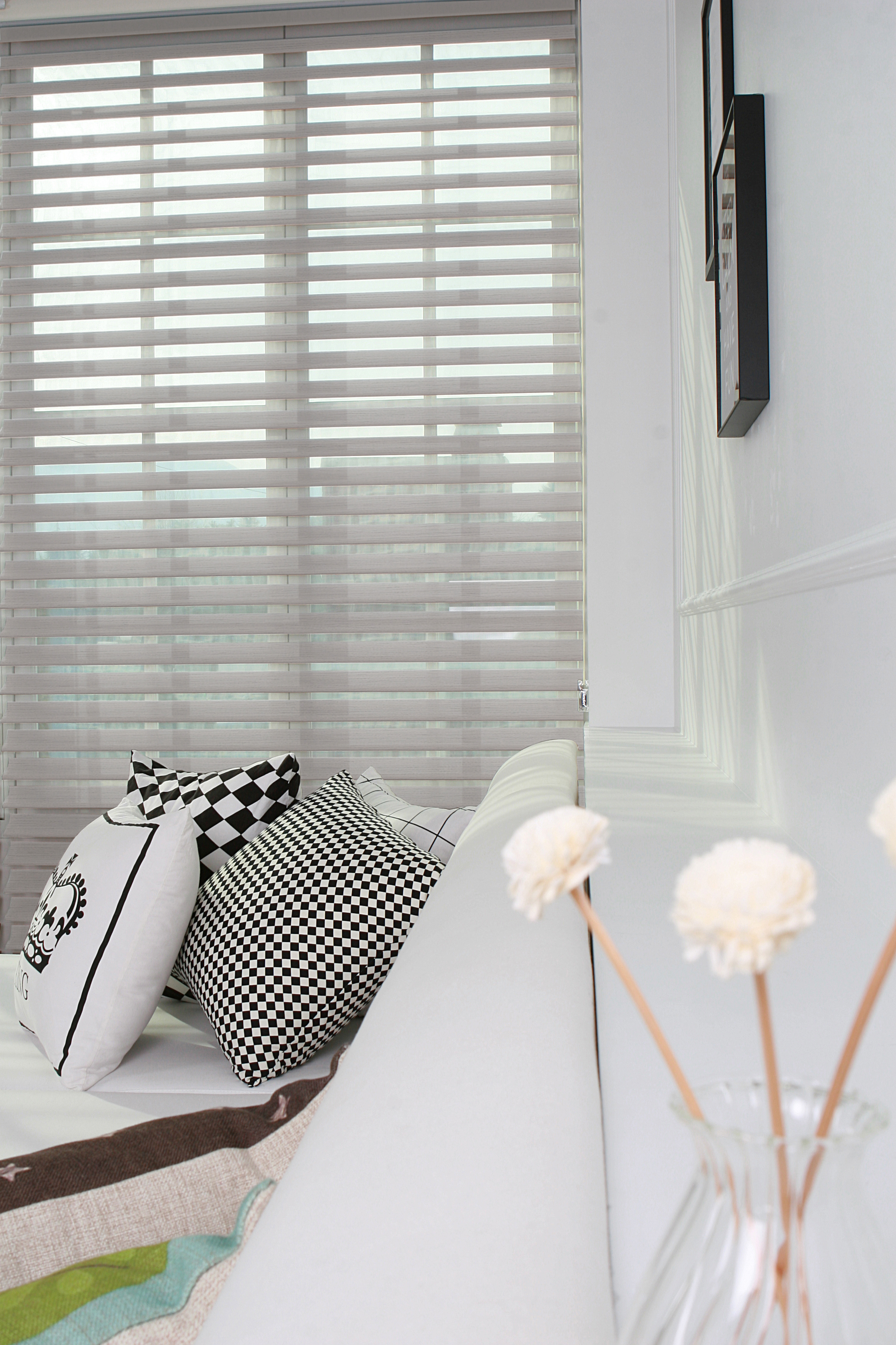 Layered zebra shade detail in a bright room.